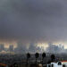 Thick heavy smoke from wildfires shrouds downtown Los Angeles on Wednesday, Jan. 8, 2025. (AP Photo/Richard Vogel)