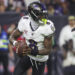 Dec 25, 2024; Houston, Texas, USA;  Baltimore Ravens quarterback Lamar Jackson (8) rolls out of the pocket with the ball during the game against the Houston Texans at NRG Stadium. Mandatory Credit: Troy Taormina-Imagn Images