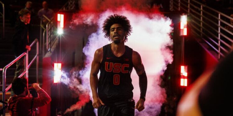 USC forward Saint Thomas exits a tunnel of smoke and steps on the Galen Center before a game against Oregon