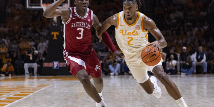 Tennessee guard Chaz Lanier (2) drives against Arkansas forward Adou Thiero (3) during the first half of an NCAA college basketball game Saturday, Jan. 4, 2025, in Knoxville, Tenn. (AP Photo/Wade Payne)