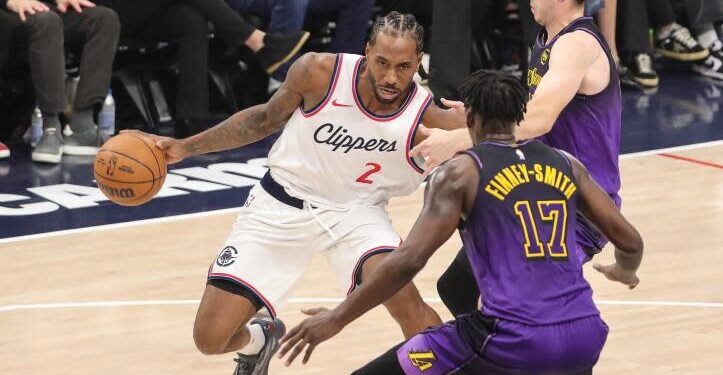 Clippers forward Kawhi Leonard, center, tries to drive past Lakers forwards Austin Reaves, top, and Dorian Finney-Smith