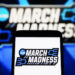 UKRAINE - 2024/04/09: In this photo illustration, a March Madness (NCAA Division I men's basketball tournament) logo is seen on a smartphone and a pc screen. (Photo Illustration by Pavlo Gonchar/SOPA Images/LightRocket via Getty Images)