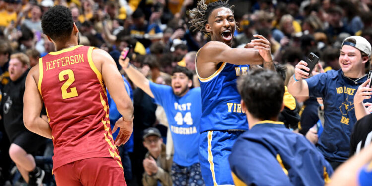 MORGANTOWN, WEST VIRGINIA - JANUARY 18: Javon Small #7 of the West Virginia Mountaineers celebrates as fans storm the court after a 64-57 victory against the Iowa State Cyclones at WVU Coliseum on January 18, 2025 in Morgantown, West Virginia. (Photo by Greg Fiume/Getty Images)