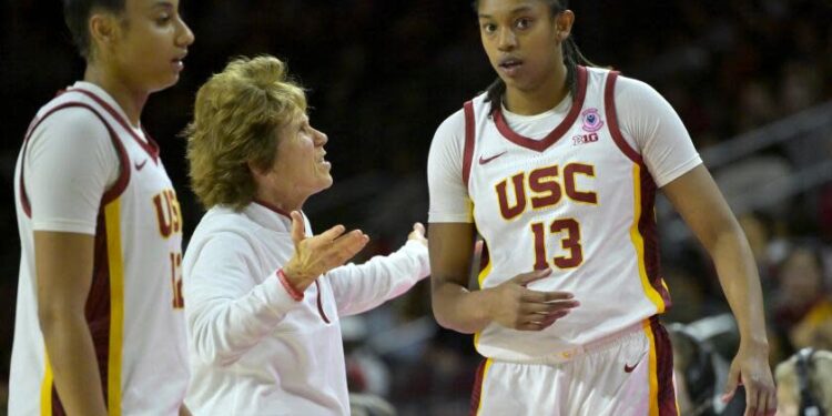 Southern California associate head coach Beth Burns talks with Southern California center Rayah Marshall (13) as Southern California guard JuJu Watkins, left, looks on during an NCAA college basketball game against Penn State, Sunday, Jan. 12, 2025, in Los Angeles. (AP Photo/Jayne Kamin-Oncea)