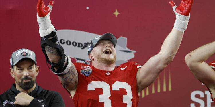 ARLINGTON, TEXAS - JANUARY 10: Jack Sawyer #33 of the Ohio State Buckeyes celebrates during the trophy ceremony after beating the Texas Longhorns 28-14 to win the Goodyear Cotton Bowl at AT&T Stadium on January 10, 2025 in Arlington, Texas. (Photo by Ron Jenkins/Getty Images)