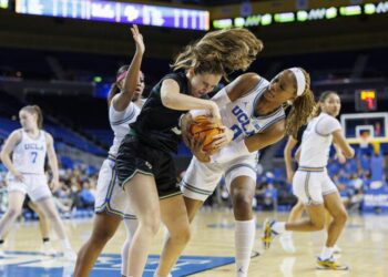 UCLA forward Janiah Barker battles Cal Poly forward Nora Perez to force a jump ball at Pauley Pavilion.