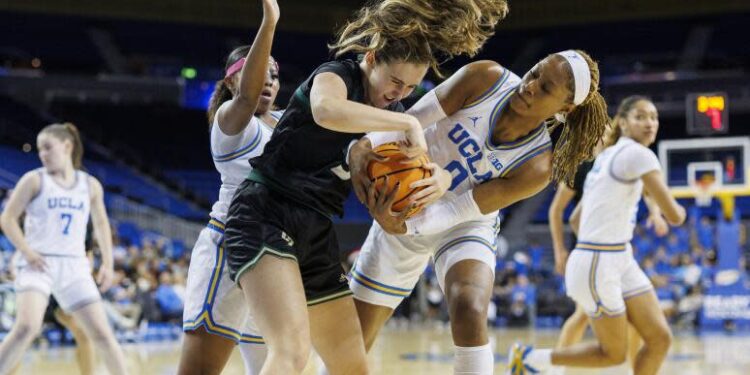 UCLA forward Janiah Barker battles Cal Poly forward Nora Perez to force a jump ball at Pauley Pavilion.