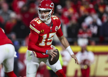 KANSAS CITY, MISSOURI - JANUARY 18: Patrick Mahomes #15 of the Kansas City Chiefs scrambles out of the pocket during an NFL football AFC divisional playoff game against the Houston Texans at GEHA Field at Arrowhead Stadium on January 18, 2025 in Kansas City, Missouri.  (Photo by Perry Knotts/Getty Images)