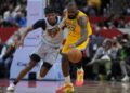 Washington Wizards guard Bilal Coulibaly (0) defends as Los Angeles Lakers forward LeBron James.