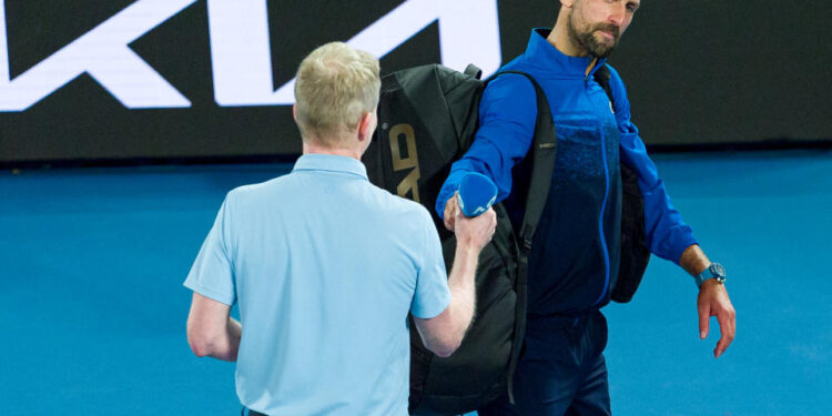 MELBOURNE, AUSTRALIA - JANUARY 19: Novak Djokovic of Serbia hands the microphone back to Jim Courier after speaking to the crowd following victory against Jiri Lehecka of the Czech Republic in the Men's Singles Fourth Round match during day eight of the 2025 Australian Open at Melbourne Park on January 19, 2025 in Melbourne, Australia. (Photo by Andy Cheung/Getty Images)