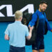 MELBOURNE, AUSTRALIA - JANUARY 19: Novak Djokovic of Serbia hands the microphone back to Jim Courier after speaking to the crowd following victory against Jiri Lehecka of the Czech Republic in the Men's Singles Fourth Round match during day eight of the 2025 Australian Open at Melbourne Park on January 19, 2025 in Melbourne, Australia. (Photo by Andy Cheung/Getty Images)