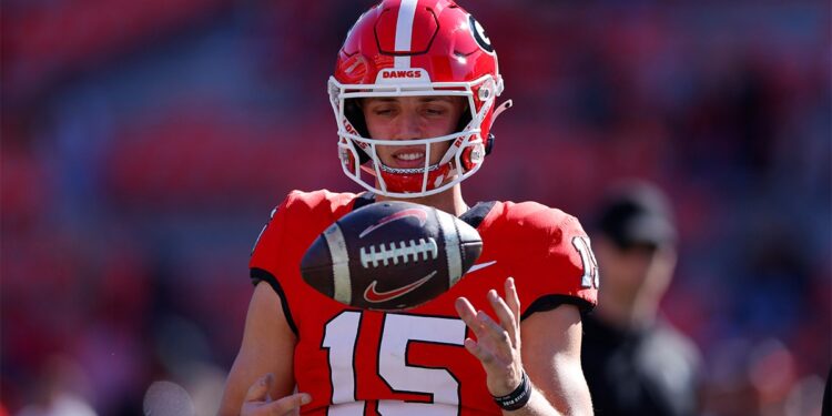 Carson Beck warms up