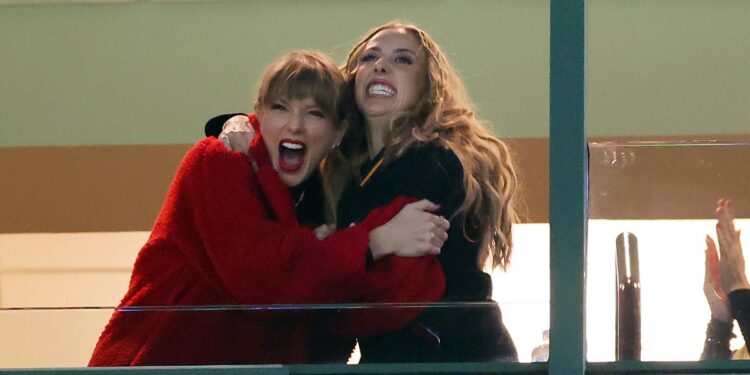 Taylor Swift and Brittany Mahomes hug at a football game