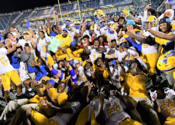 Miami Northwestern's team poses for a photo following their victory over Raines in the Class 3A state championship at Florida International University on Dec. 14, 2024.