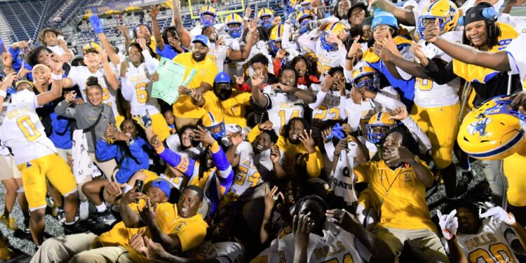 Miami Northwestern's team poses for a photo following their victory over Raines in the Class 3A state championship at Florida International University on Dec. 14, 2024.