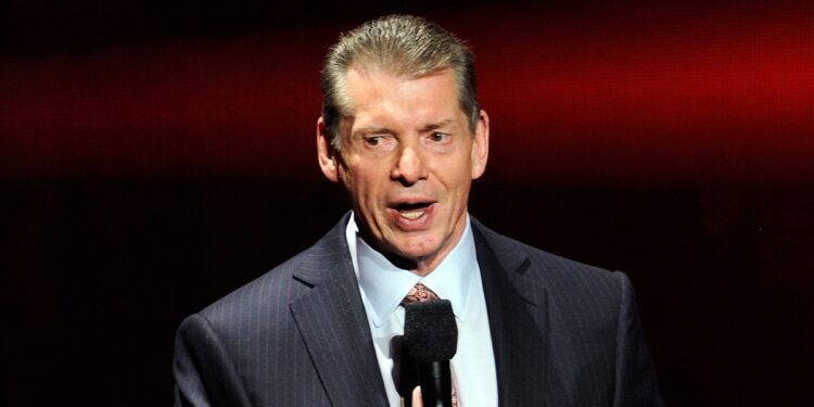 Vince McMahon talks into microphone