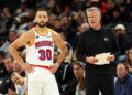 MINNEAPOLIS, MINNESOTA - DECEMBER 21: Stephen Curry #30 interacts with head coach Steve Kerr of the Golden State Warriors in the fourth quarter of the game against the Minnesota Timberwolves at Target Center on December 21, 2024 in Minneapolis, Minnesota. The Warriors defeated the Timberwolves 113-103. NOTE TO USER: User expressly acknowledges and agrees that, by downloading and or using this photograph, User is consenting to the terms and conditions of the Getty Images License Agreement. (Photo by David Berding/Getty Images)