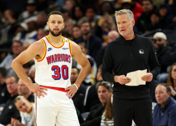 MINNEAPOLIS, MINNESOTA - DECEMBER 21: Stephen Curry #30 interacts with head coach Steve Kerr of the Golden State Warriors in the fourth quarter of the game against the Minnesota Timberwolves at Target Center on December 21, 2024 in Minneapolis, Minnesota. The Warriors defeated the Timberwolves 113-103. NOTE TO USER: User expressly acknowledges and agrees that, by downloading and or using this photograph, User is consenting to the terms and conditions of the Getty Images License Agreement. (Photo by David Berding/Getty Images)