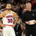 MINNEAPOLIS, MINNESOTA - DECEMBER 21: Stephen Curry #30 interacts with head coach Steve Kerr of the Golden State Warriors in the fourth quarter of the game against the Minnesota Timberwolves at Target Center on December 21, 2024 in Minneapolis, Minnesota. The Warriors defeated the Timberwolves 113-103. NOTE TO USER: User expressly acknowledges and agrees that, by downloading and or using this photograph, User is consenting to the terms and conditions of the Getty Images License Agreement. (Photo by David Berding/Getty Images)