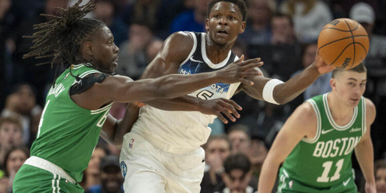 Jan 2, 2025; Minneapolis, Minnesota, USA; Minnesota Timberwolves guard Anthony Edwards (5) passes around Boston Celtics guard Jrue Holiday (4) in the first half at Target Center. Mandatory Credit: Jesse Johnson-Imagn Images