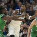 Jan 2, 2025; Minneapolis, Minnesota, USA; Minnesota Timberwolves guard Anthony Edwards (5) passes around Boston Celtics guard Jrue Holiday (4) in the first half at Target Center. Mandatory Credit: Jesse Johnson-Imagn Images