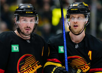 VANCOUVER, CANADA - JANUARY 25: Elias Pettersson #40 and J.T. Miller #9 of the Vancouver Canucks wait for a face off during the first period of their NHL game against the Washington Capitals at Rogers Arena on January 25, 2025 in Vancouver, British Columbia, Canada. (Photo by Derek Cain/Getty Images)