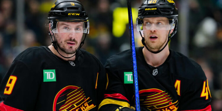 VANCOUVER, CANADA - JANUARY 25: Elias Pettersson #40 and J.T. Miller #9 of the Vancouver Canucks wait for a face off during the first period of their NHL game against the Washington Capitals at Rogers Arena on January 25, 2025 in Vancouver, British Columbia, Canada. (Photo by Derek Cain/Getty Images)