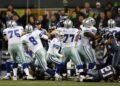 Quarterback Tony Romo picks up the fumbled snap on a game-winning field goal attempt in a playoff game against the Seattle Seahawks on January 6, 2007. (Jed Jacobsohn/Getty Images)