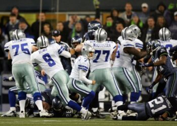 Quarterback Tony Romo picks up the fumbled snap on a game-winning field goal attempt in a playoff game against the Seattle Seahawks on January 6, 2007. (Jed Jacobsohn/Getty Images)