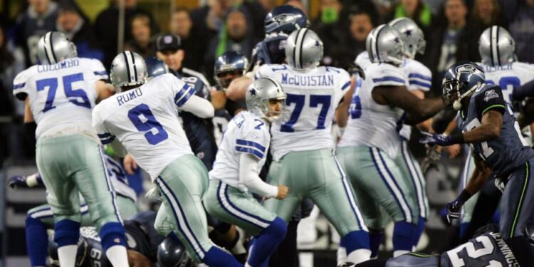 Quarterback Tony Romo picks up the fumbled snap on a game-winning field goal attempt in a playoff game against the Seattle Seahawks on January 6, 2007. (Jed Jacobsohn/Getty Images)