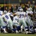 Quarterback Tony Romo picks up the fumbled snap on a game-winning field goal attempt in a playoff game against the Seattle Seahawks on January 6, 2007. (Jed Jacobsohn/Getty Images)