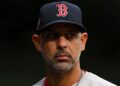 Boston Red Sox manager Alex Cora looks on from dugout