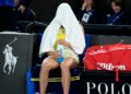 Aryna Sabalenka with towel over head