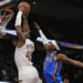 Cleveland Cavaliers guard Donovan Mitchell (45) goes up for a dunk in front of Oklahoma City Thunder guard Shai Gilgeous-Alexander (2) in the first half of an NBA basketball game, Wednesday, Jan. 8, 2025, in Cleveland. (AP Photo/Sue Ogrocki)