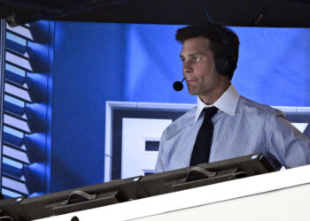 FILE 0- Former NFL quarterback Tom Brady looks on from the broadcast booth during the second half of an NFL football game between the Dallas Cowboys and the New Orleans Saints, Sunday, Sept. 15, 2024, in Arlington, Texas. (AP Photo/Jerome Miron, File)