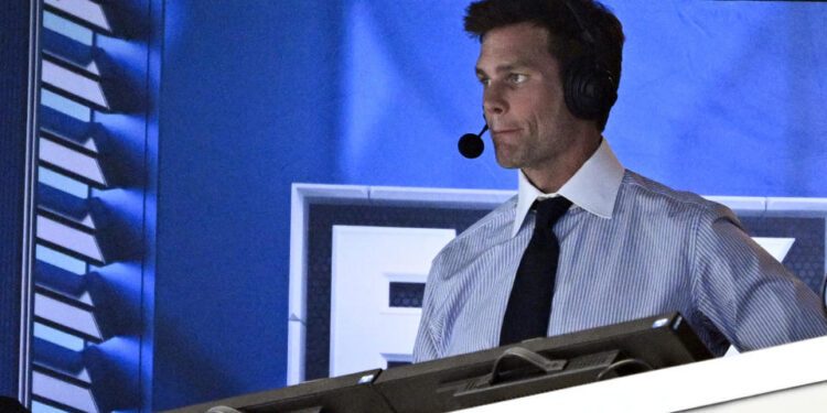 FILE 0- Former NFL quarterback Tom Brady looks on from the broadcast booth during the second half of an NFL football game between the Dallas Cowboys and the New Orleans Saints, Sunday, Sept. 15, 2024, in Arlington, Texas. (AP Photo/Jerome Miron, File)