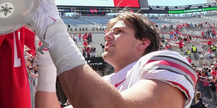 Caden Davis signs an autograph