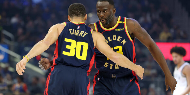 SAN FRANCISCO, CALIFORNIA - NOVEMBER 25: Stephen Curry #30 hugs Draymond Green #23 of the Golden State Warriors before their game against the Brooklyn Nets at Chase Center on November 25, 2024 in San Francisco, California. NOTE TO USER: User expressly acknowledges and agrees that, by downloading and/or using this photograph, user is consenting to the terms and conditions of the Getty Images License Agreement.   (Photo by Ezra Shaw/Getty Images)