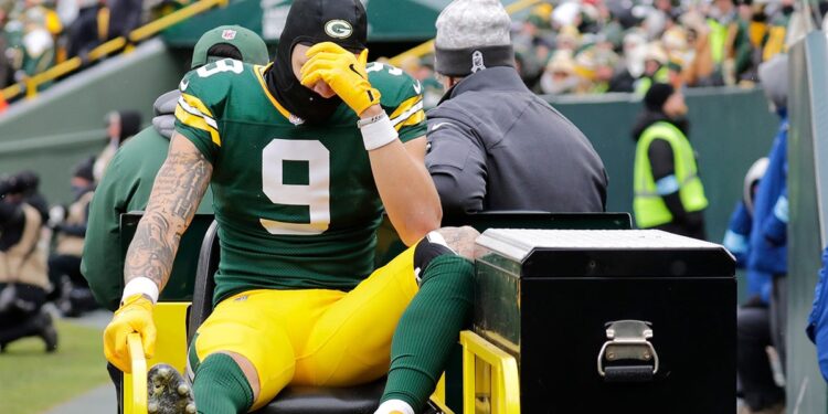 Christian Watson leaves field on cart