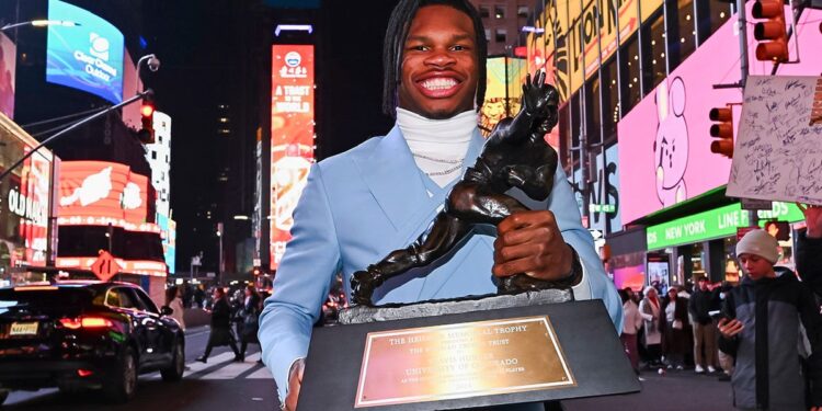 Travis Hunter holds the Heisman Trophy