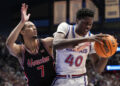 LAWRENCE, KANSAS - JANUARY 25: Flory Bidunga #40 of the Kansas Jayhawks drives to the basket as he is defended by Milos Uzan #7 of the Houston Cougars in the first half at Allen Fieldhouse on January 25, 2025 in Lawrence, Kansas. (Photo by Ed Zurga/Getty Images)