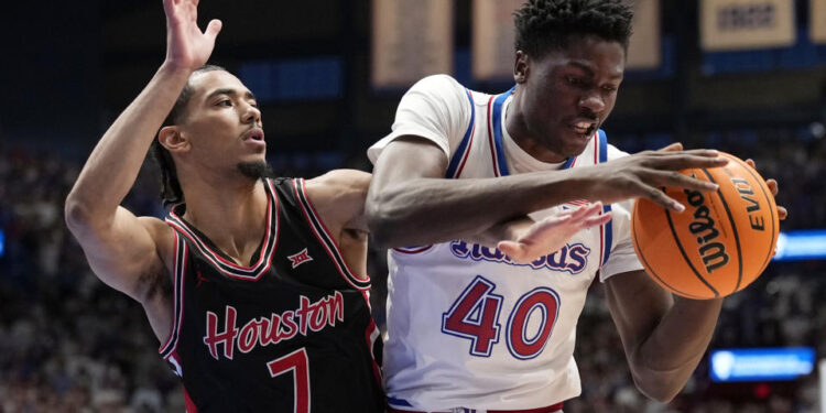 LAWRENCE, KANSAS - JANUARY 25: Flory Bidunga #40 of the Kansas Jayhawks drives to the basket as he is defended by Milos Uzan #7 of the Houston Cougars in the first half at Allen Fieldhouse on January 25, 2025 in Lawrence, Kansas. (Photo by Ed Zurga/Getty Images)