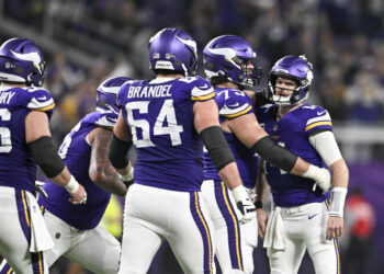 MINNEAPOLIS, MINNESOTA - DECEMBER 29: Quarterback Sam Darnold #14 of the Minnesota Vikings celebrates with Brian O'Neill #75 after a throwing a touchdown pass during the third quarter against the Green Bay Packers at U.S. Bank Stadium on December 29, 2024 in Minneapolis, Minnesota. (Photo by Stephen Maturen/Getty Images)