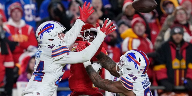 Xavier Worthy jumps for the ball