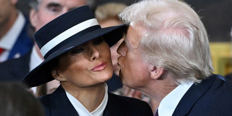 US President-elect Donald Trump kisses Melania Trump as he arrives for the inauguration ceremony