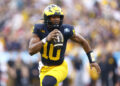 TAMPA, FLORIDA - DECEMBER 31: Alex Orji #10 of the Michigan Wolverines runs with the ball during the first quarter against the Alabama Crimson Tide in the 2024 ReliaQuest Bowl at Raymond James Stadium on December 31, 2024 in Tampa, Florida.  (Photo by Douglas P. DeFelice/Getty Images)