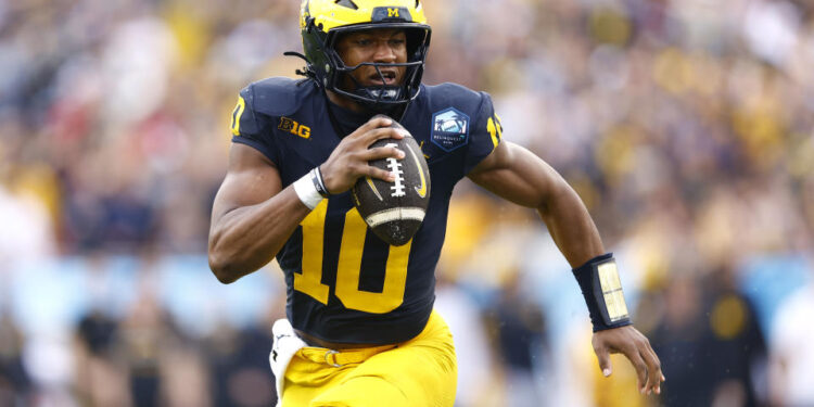 TAMPA, FLORIDA - DECEMBER 31: Alex Orji #10 of the Michigan Wolverines runs with the ball during the first quarter against the Alabama Crimson Tide in the 2024 ReliaQuest Bowl at Raymond James Stadium on December 31, 2024 in Tampa, Florida.  (Photo by Douglas P. DeFelice/Getty Images)