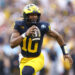 TAMPA, FLORIDA - DECEMBER 31: Alex Orji #10 of the Michigan Wolverines runs with the ball during the first quarter against the Alabama Crimson Tide in the 2024 ReliaQuest Bowl at Raymond James Stadium on December 31, 2024 in Tampa, Florida.  (Photo by Douglas P. DeFelice/Getty Images)