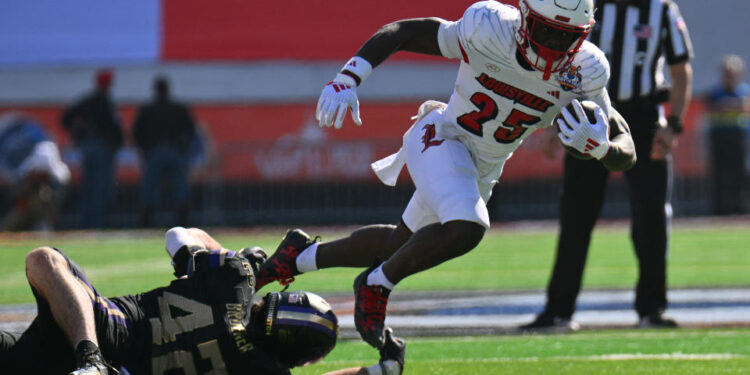 EL PASO, TEXAS - DECEMBER 31: Running back Isaac Brown #25 of the Louisville Cardinals escapes a tackle from linebacker Carson Bruener #42 of the Washington Huskies during the first half of the Tony the Tiger Sun Bowl at Sun Bowl Stadium on December 31, 2024 in El Paso, Texas. (Photo by Sam Wasson/Getty Images)