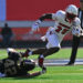 EL PASO, TEXAS - DECEMBER 31: Running back Isaac Brown #25 of the Louisville Cardinals escapes a tackle from linebacker Carson Bruener #42 of the Washington Huskies during the first half of the Tony the Tiger Sun Bowl at Sun Bowl Stadium on December 31, 2024 in El Paso, Texas. (Photo by Sam Wasson/Getty Images)